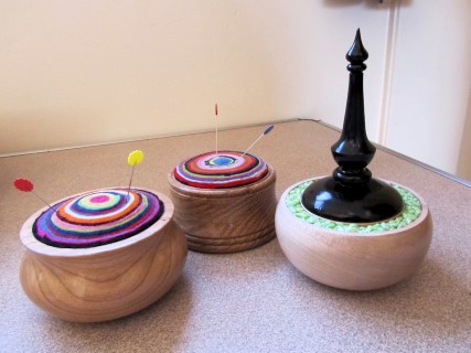 Two pin cushions and a pot by Len Laker